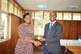 Faculty of Health Sciences Prof. Daniel Ojuka presents an award to Dr. Loise Ombanjo who emerged top in the Resource Mobilization category.